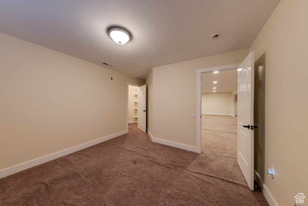 Unfurnished bedroom featuring baseboards, visible vents, and carpet