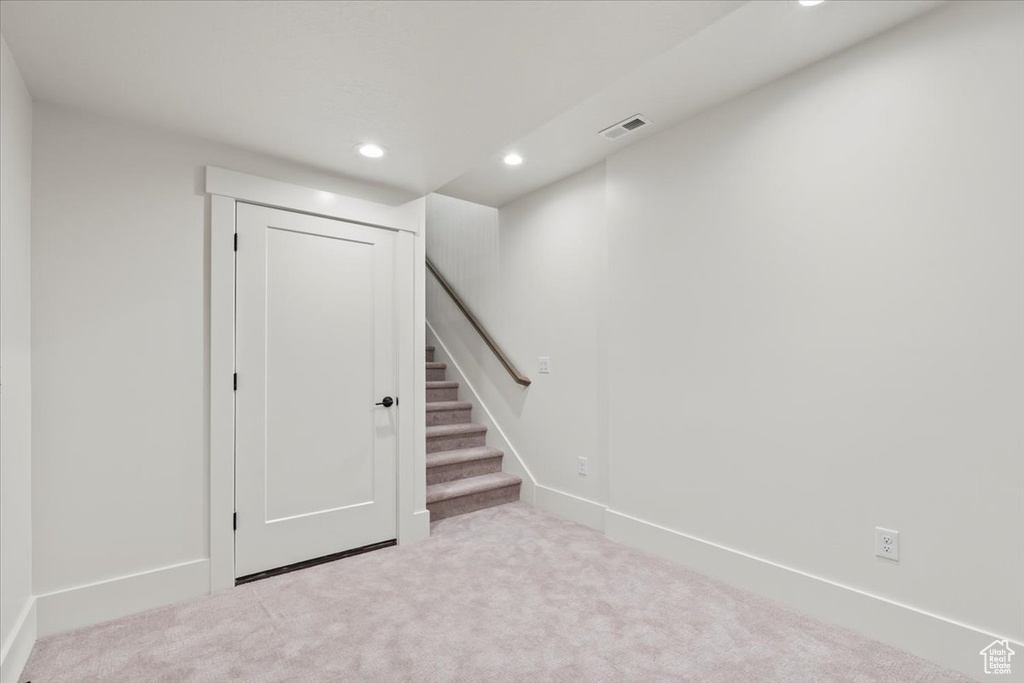 Below grade area featuring recessed lighting, carpet floors, stairs, and baseboards