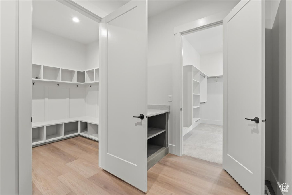 Mudroom with light wood finished floors and recessed lighting