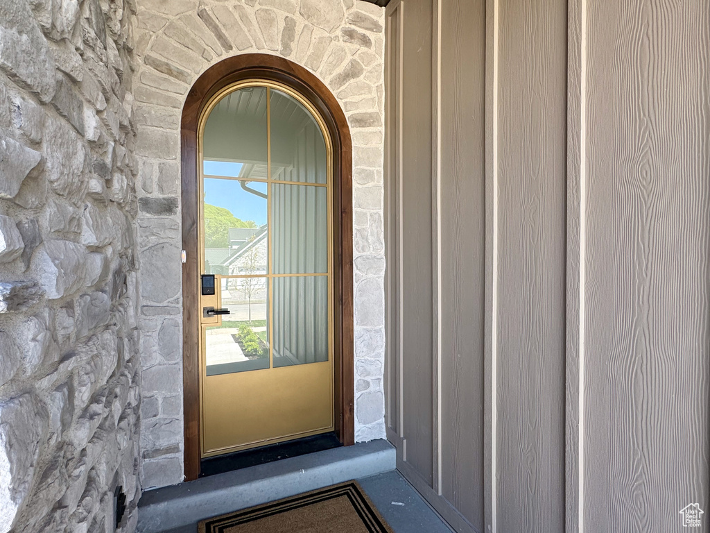 Doorway to property featuring stone siding