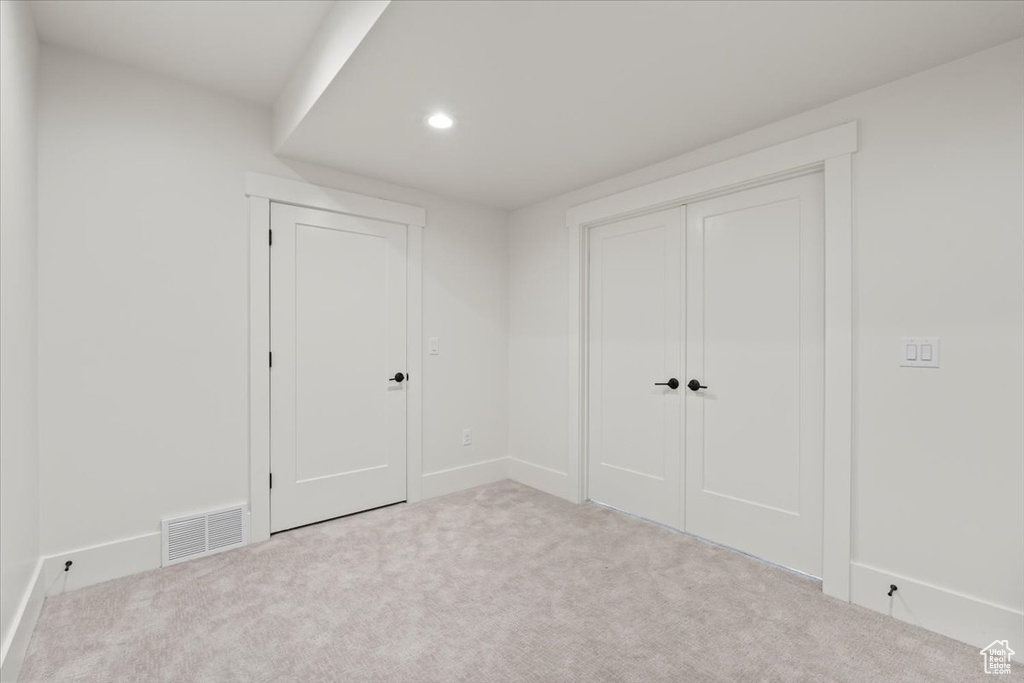 Unfurnished bedroom with carpet flooring, recessed lighting, baseboards, and a closet
