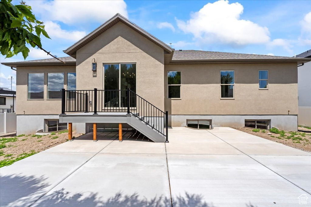 Rear view of property with a patio and stucco siding