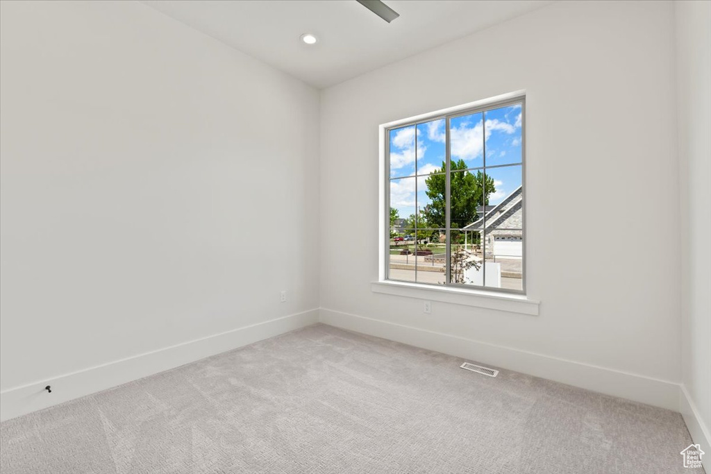 Empty room with carpet floors, baseboards, and recessed lighting