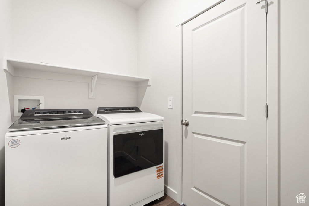 Laundry room featuring washer and clothes dryer and wood finished floors