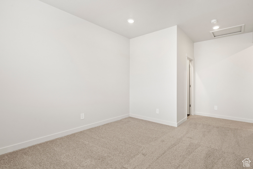 Empty room with carpet flooring, recessed lighting, and baseboards