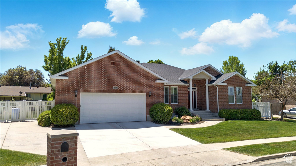 View of front of home with brick siding, a garage, and concrete driveway