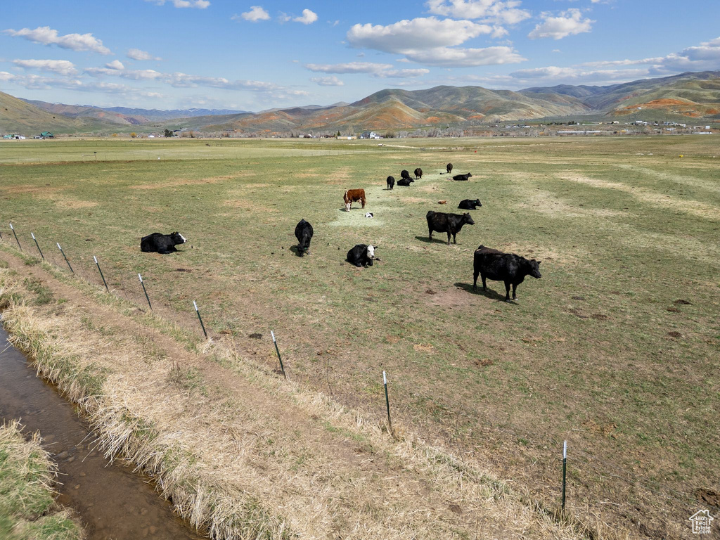 View of mountain backdrop with rural landscape and a pastoral area