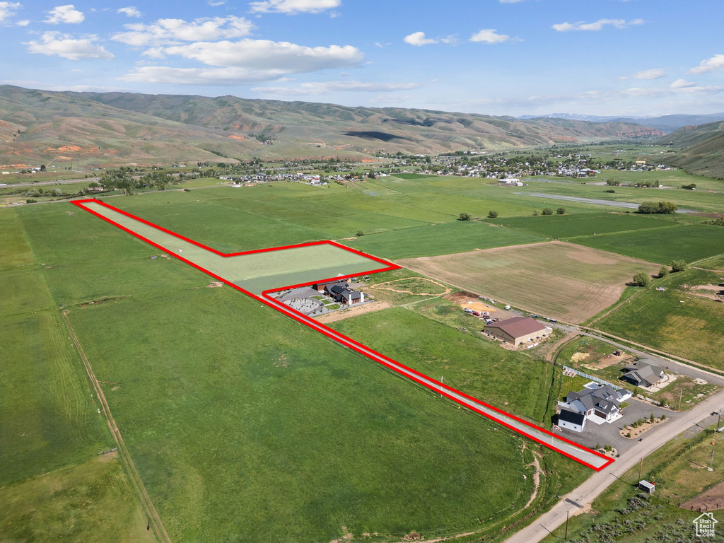 Overview of rural landscape featuring property parcel outlined and a mountain backdrop