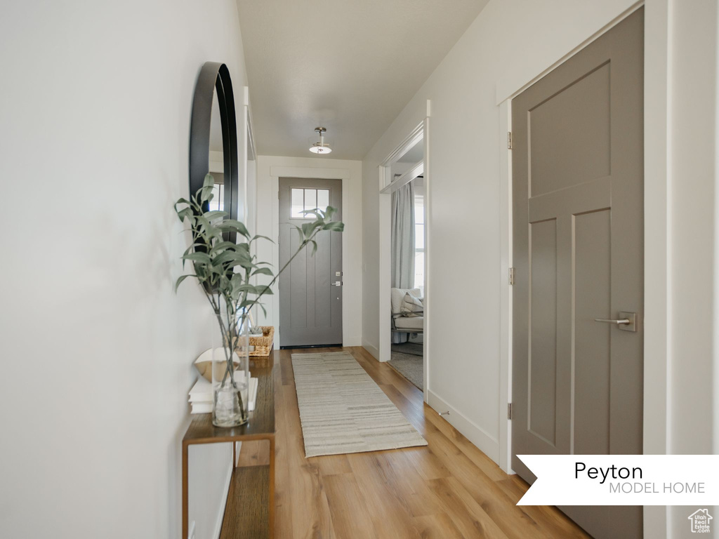 Entryway featuring baseboards and light wood finished floors