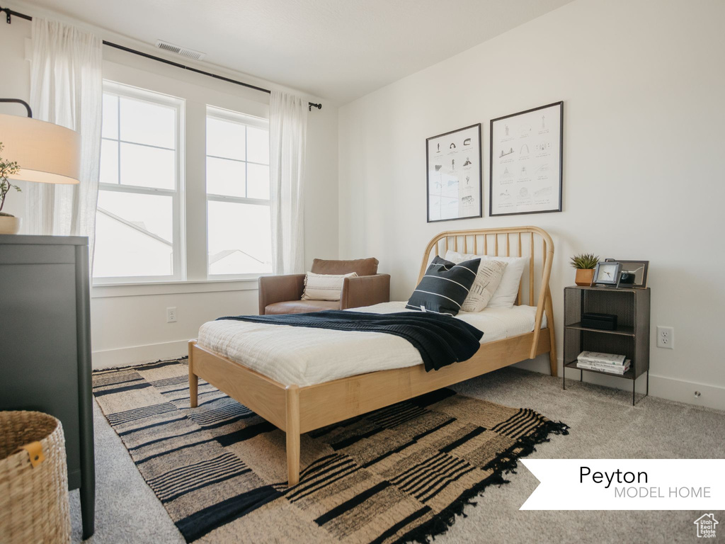 Bedroom featuring baseboards, visible vents, and carpet