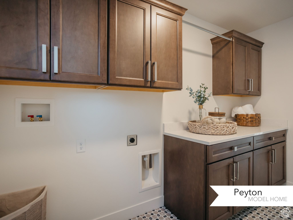 Washroom featuring hookup for a washing machine, cabinet space, baseboards, and electric dryer hookup