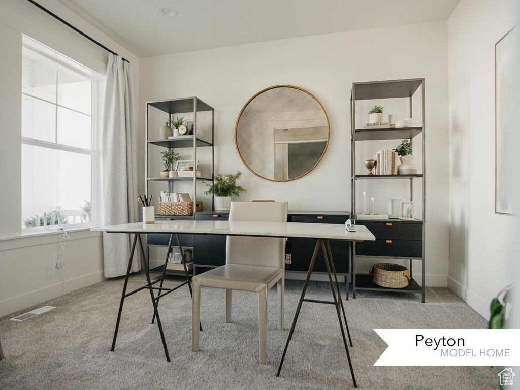 Carpeted home office with baseboards and visible vents