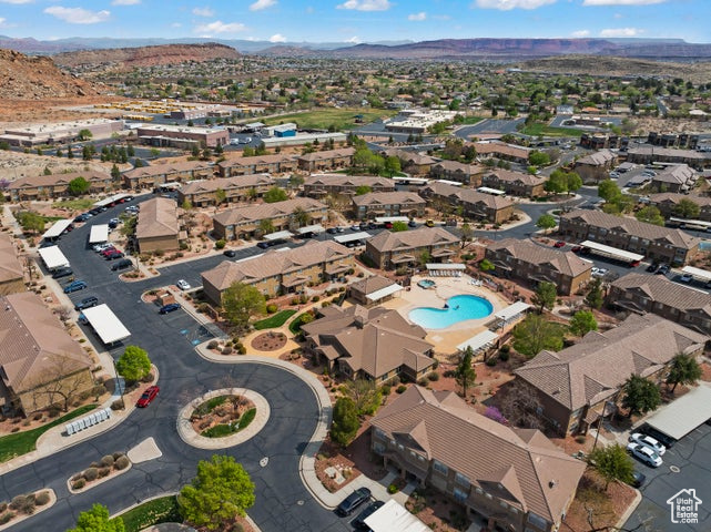 View of property location featuring mountains, nearby suburban area, and a pool area