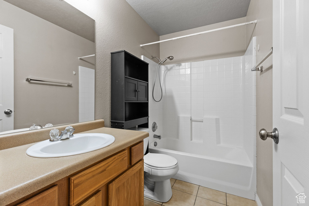 Full bath featuring tile patterned flooring, vanity, bathtub / shower combination, and toilet