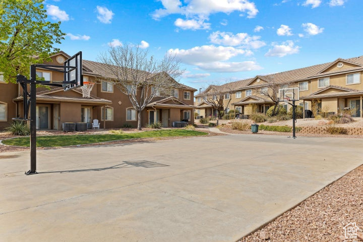 View of concrete road with a residential view and curbs