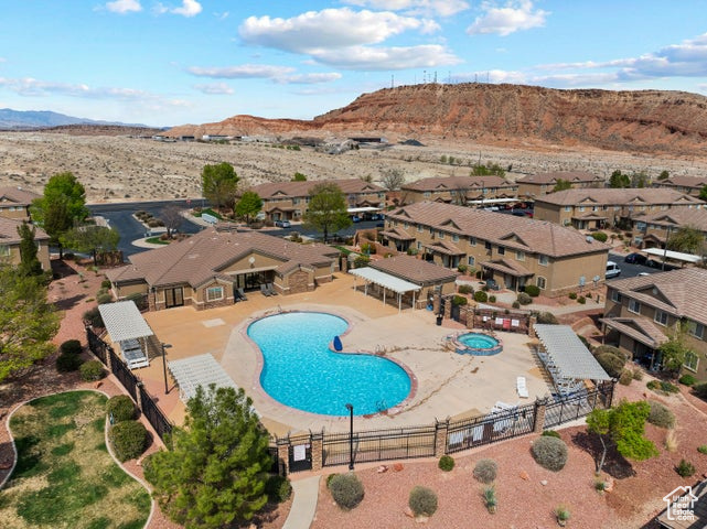 Aerial perspective of suburban area featuring mountains and a pool area