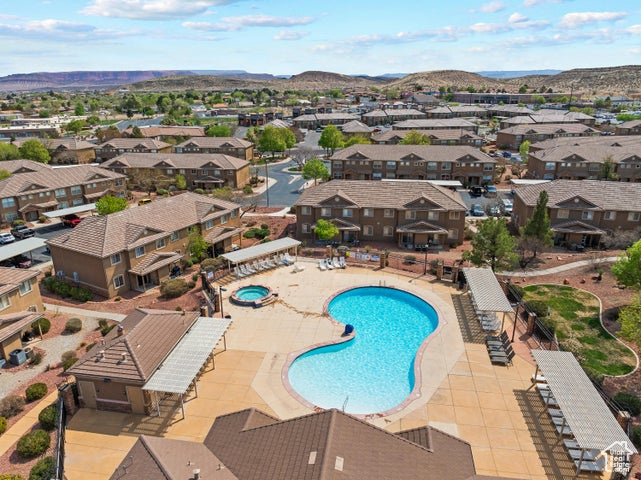 Community pool featuring a residential view, a mountain view, and a patio area
