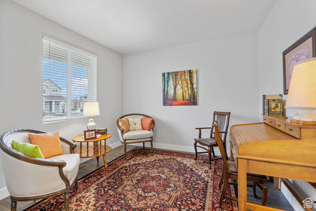 Living area featuring baseboards and wood finished floors