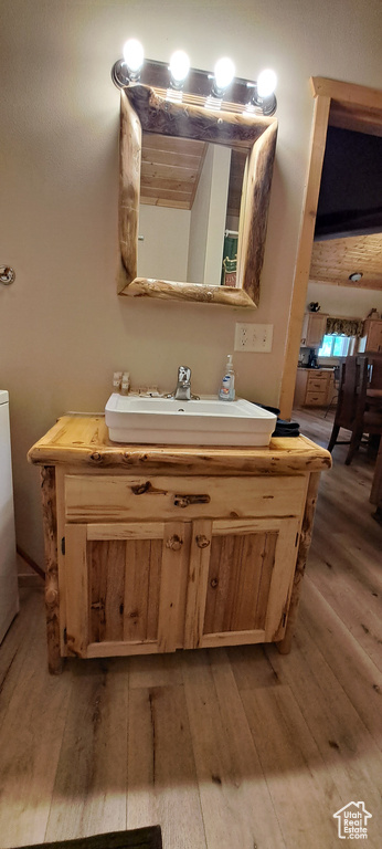 Bathroom with a sink and hardwood / wood-style flooring