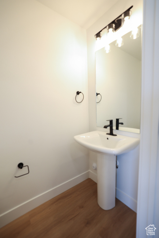 Bathroom featuring baseboards and wood finished floors