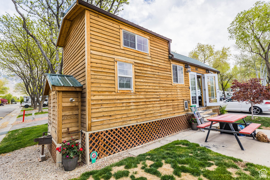 Back of property featuring metal roof and a patio