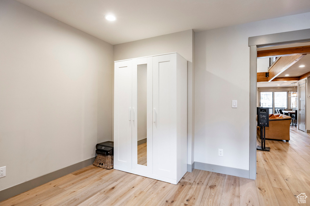 Bedroom with baseboards, a closet, light wood-style floors, and recessed lighting