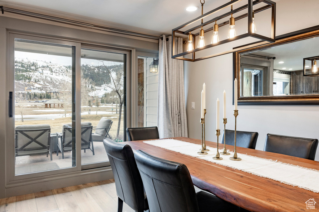 Dining room featuring a wealth of natural light, wood finished floors, and recessed lighting