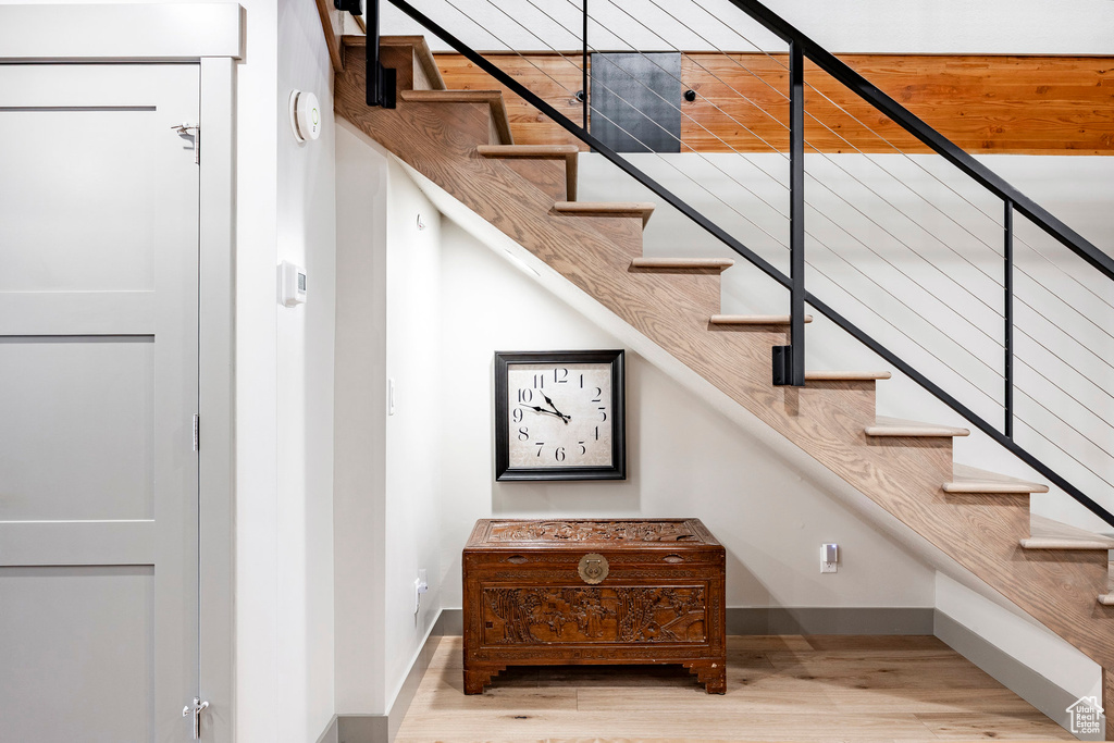Stairway featuring baseboards and wood finished floors