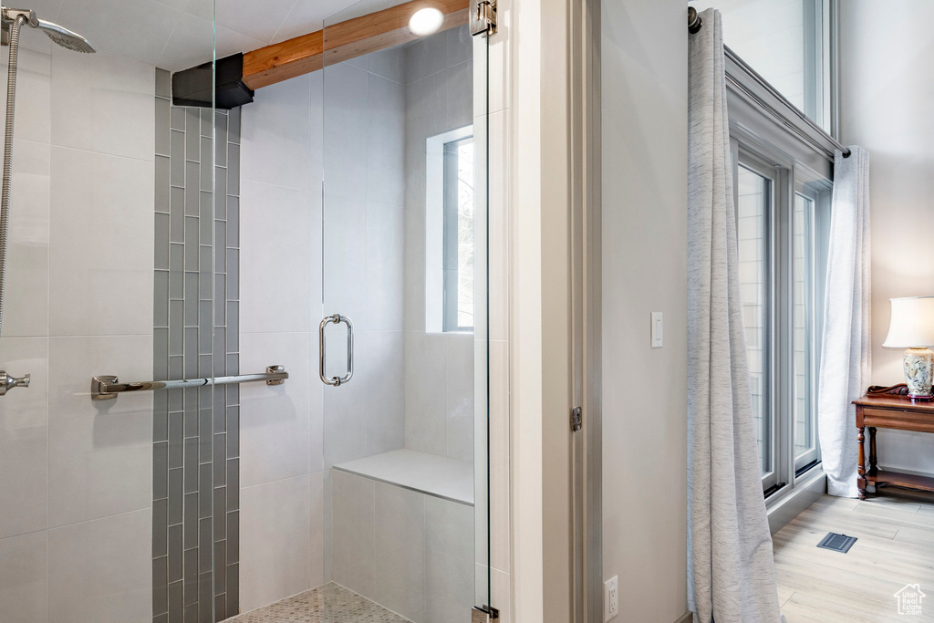 Full bathroom featuring a shower stall and beamed ceiling