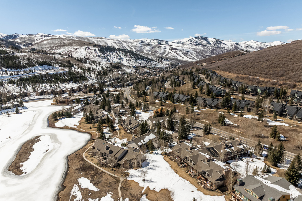 Snowy aerial view featuring a mountain view and a residential view