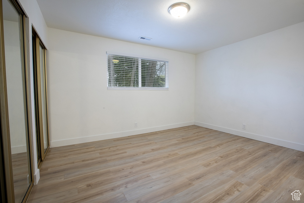 Unfurnished bedroom with a closet, light wood-type flooring, and baseboards