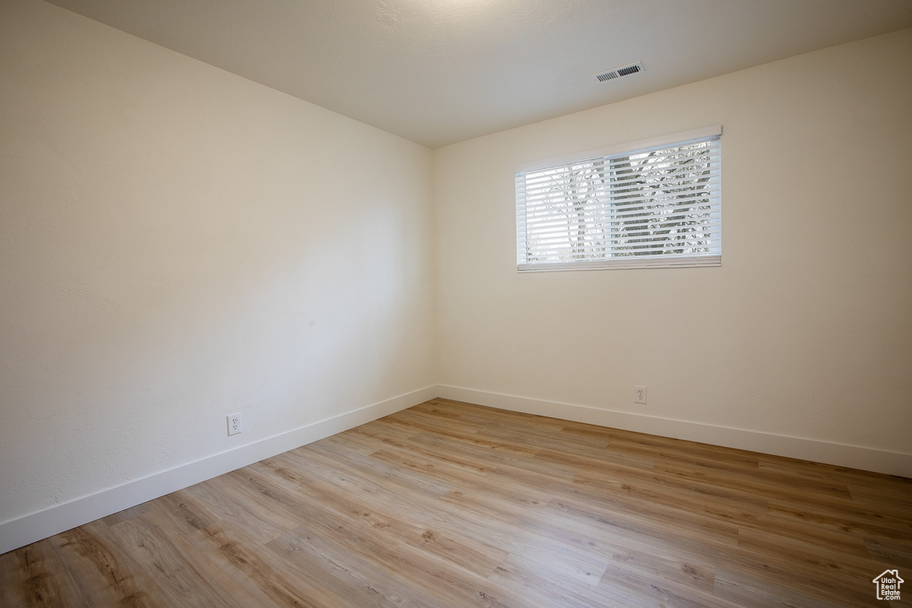 Unfurnished room with baseboards and wood finished floors