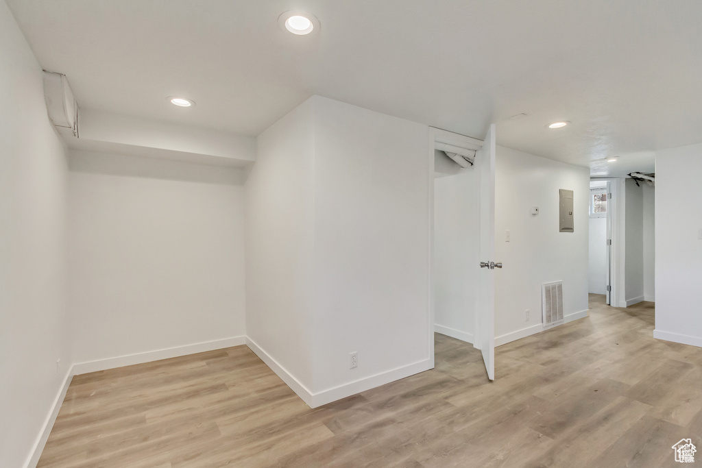 Finished below grade area featuring recessed lighting, baseboards, light wood-style floors, and visible vents