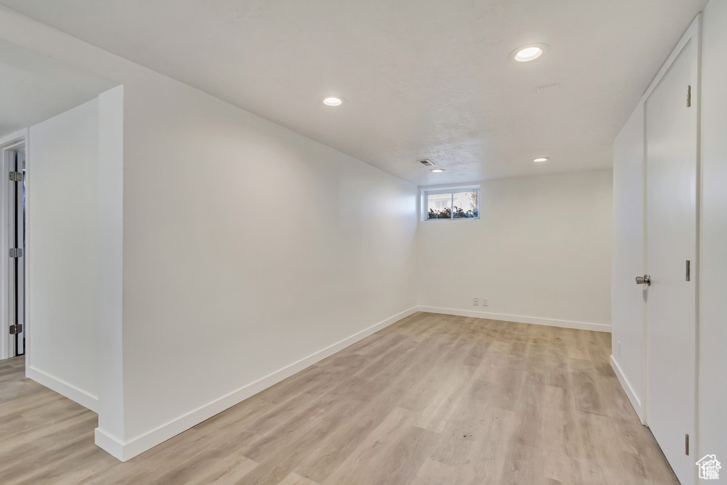Below grade area with baseboards, light wood-style flooring, and recessed lighting