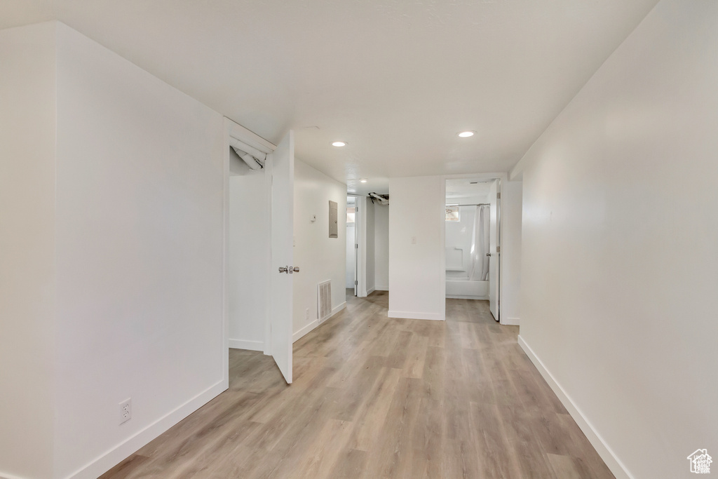 Hallway featuring recessed lighting, baseboards, light wood-style floors, and visible vents