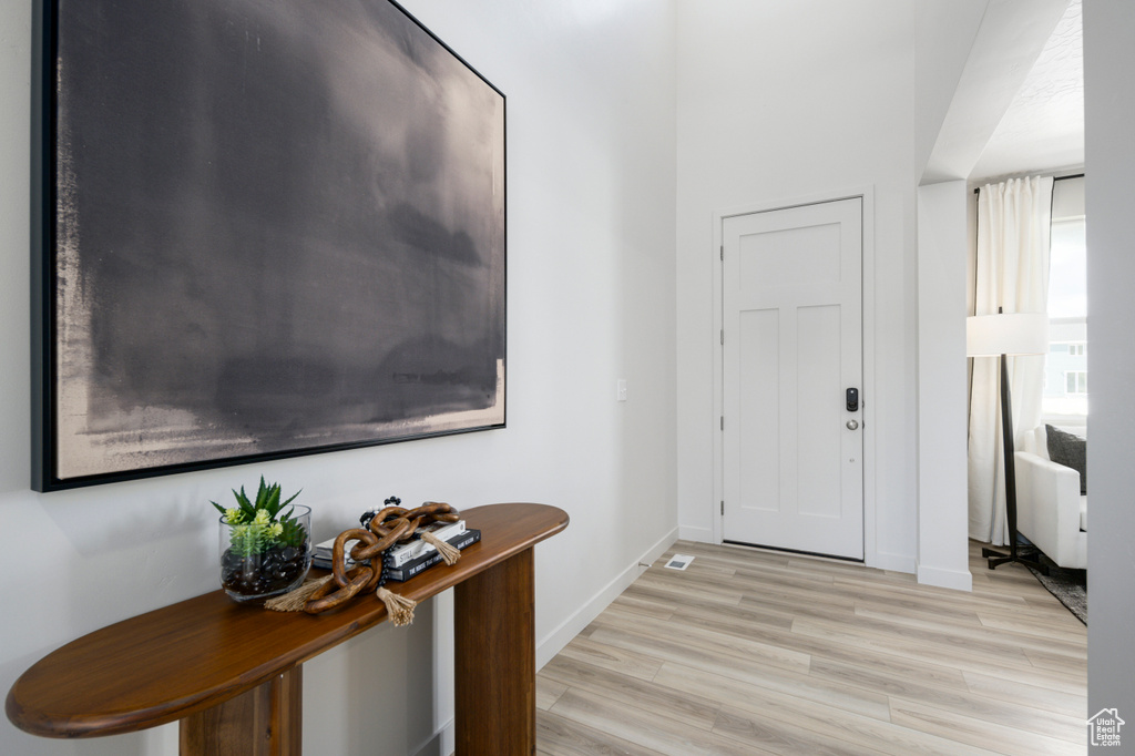 Foyer entrance featuring baseboards and light wood finished floors