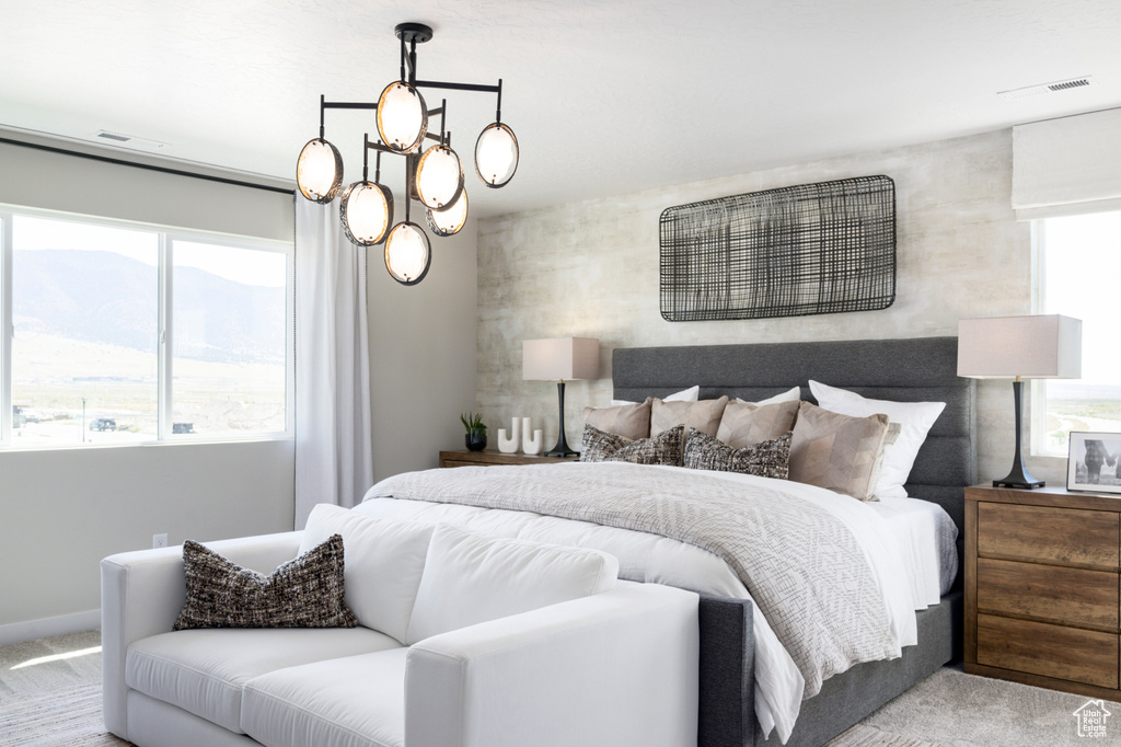 Bedroom featuring carpet, multiple windows, and visible vents