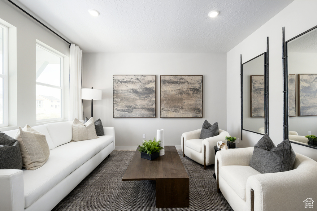 Living area featuring recessed lighting and a textured ceiling