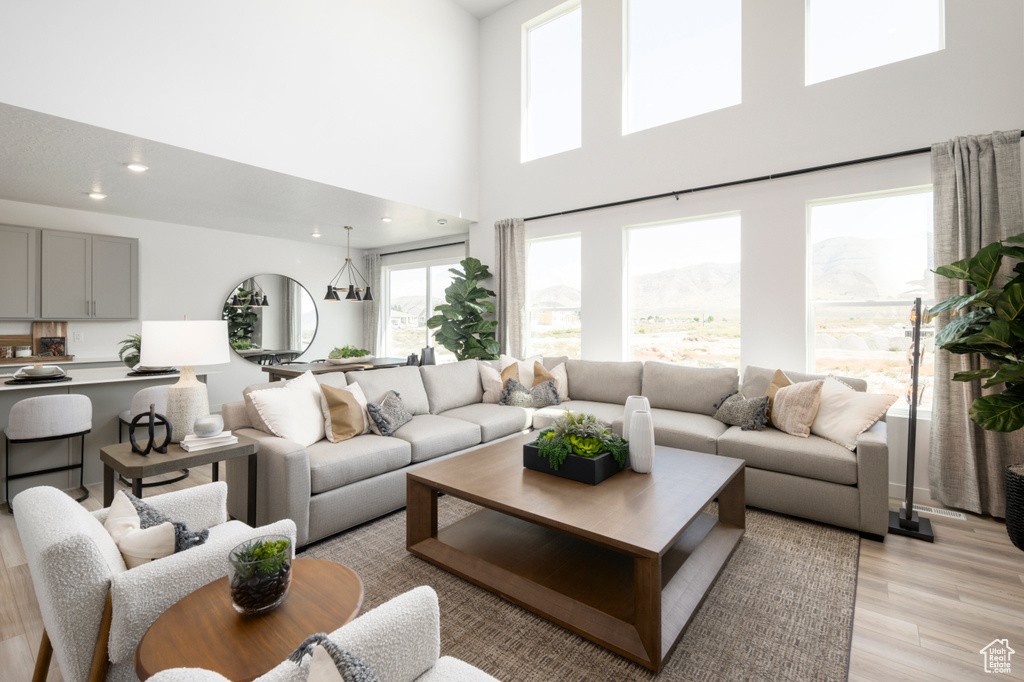Living area featuring a high ceiling and light wood finished floors