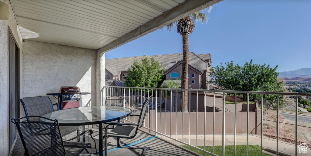 Balcony with grilling area, outdoor dining area, and a mountain view