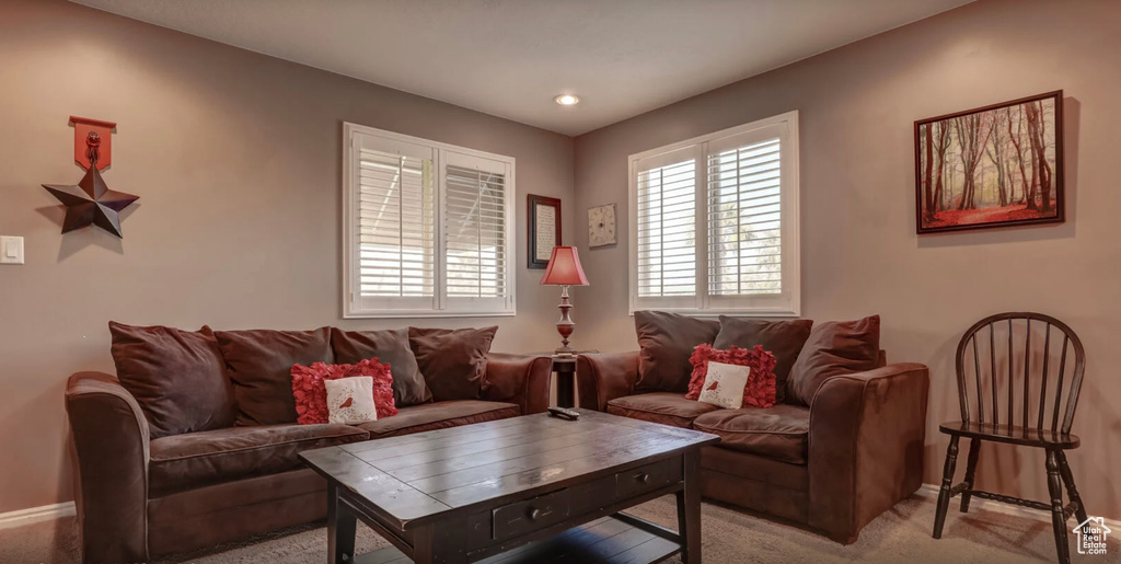 Living area featuring baseboards, recessed lighting, and light colored carpet