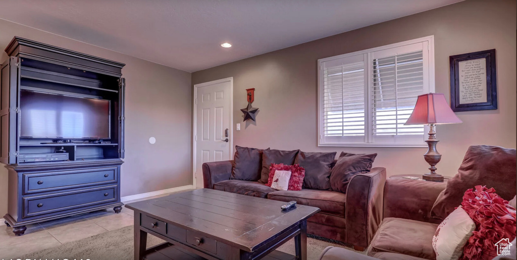 Living area with light tile patterned floors and recessed lighting