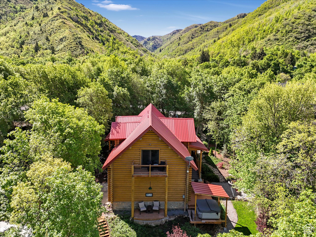 View from above of property featuring a heavily wooded area and mountains
