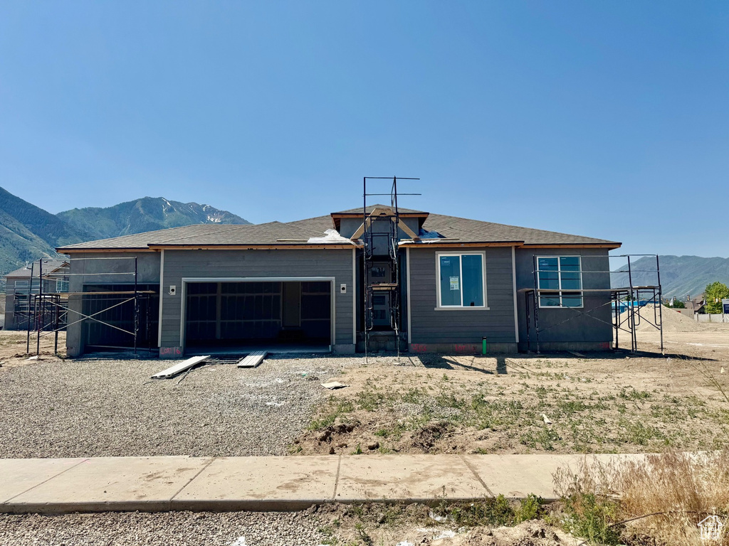 Property in mid-construction with a mountain view and a garage