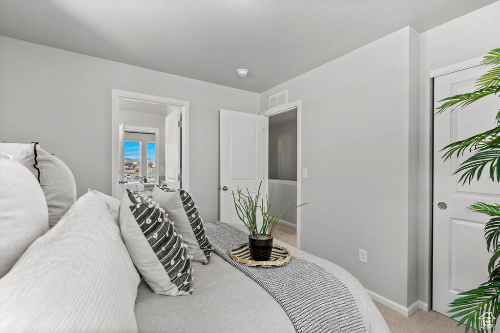 Bedroom featuring carpet, baseboards, and visible vents