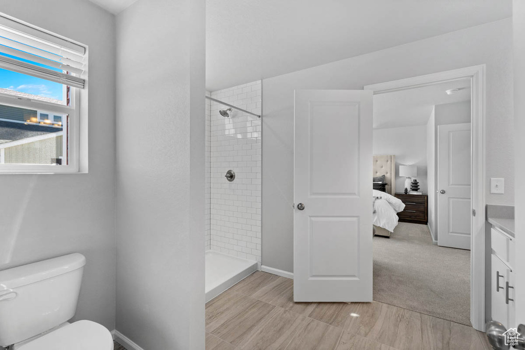Ensuite bathroom with a tile shower, toilet, and ensuite bathroom