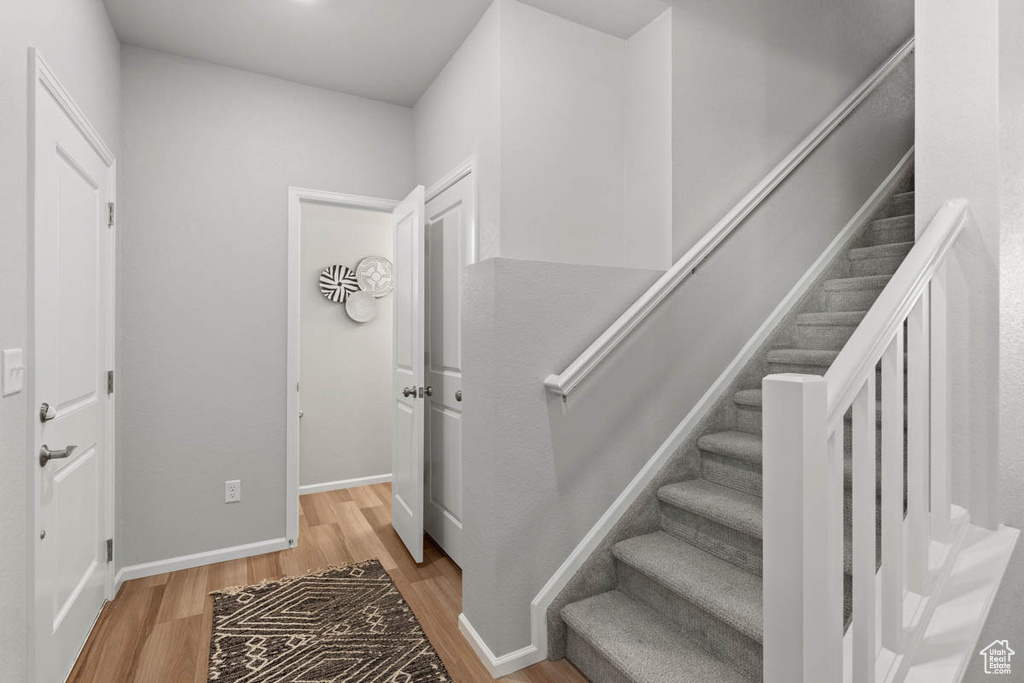 Stairs with baseboards and wood finished floors