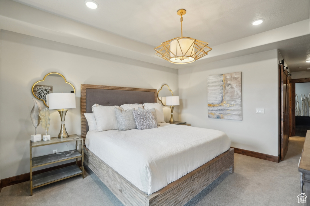 Bedroom featuring a barn door, carpet floors, baseboards, and recessed lighting