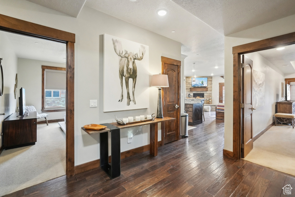 Corridor with hardwood / wood-style floors, baseboards, and recessed lighting