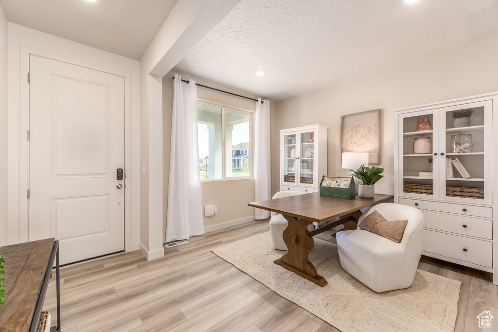 Home office featuring baseboards, visible vents, and light wood-style flooring